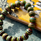 Wooden bead bracelet in green, teal and brown, made from a recycled skateboard deck in the UK.