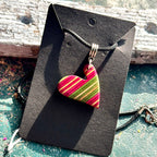 Recycled skateboard maple heart pendant with pink and green diagonal stripes, handmade by Baltic Dew.