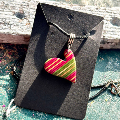 Recycled skateboard maple heart pendant with pink and green diagonal stripes, handmade by Baltic Dew.