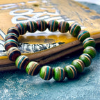 Green, teal and brown recycled skateboard wood bead bracelet, photographed by Baltic Dew.