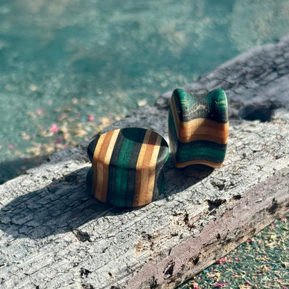 Teal and Black Double Flare Wooden Ear Plugs 16mm made from layered wood with green, black, and natural tones on rustic surface