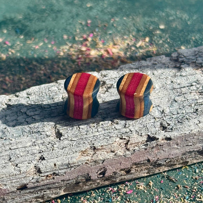 Pink and Blue Double Flare Wooden Ear Plugs 10mm made from layered wood with pink, blue, and natural tones