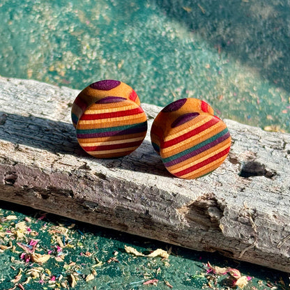 Red and purple double flare ear plugs at 16mm, striped layers from a recycled skateboard.