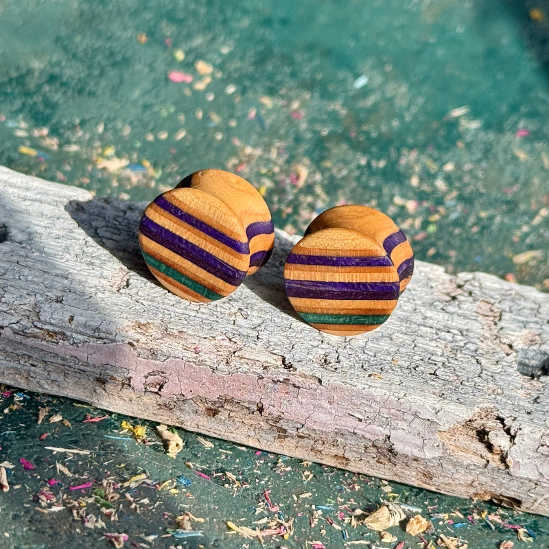 Purple and teal double flare ear plugs at 16mm in recycled skateboard maple, handmade by Baltic Dew.