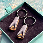 Rich black layered wood hoop earrings with natural maple details.
