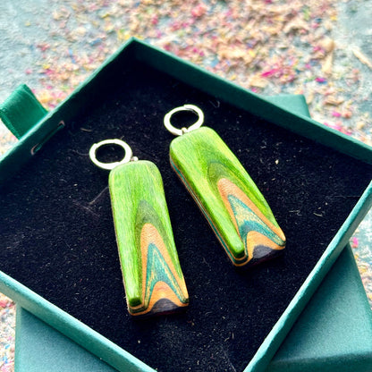 A multicolour layered ring made from recycled skateboard wood with glossy CA glue finish, handmade by Baltic Dew