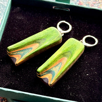 A multicolour layered ring made from recycled skateboard wood with glossy CA glue finish, handmade by Baltic Dew