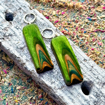 A multicolour layered ring made from recycled skateboard wood with glossy CA glue finish, handmade by Baltic Dew