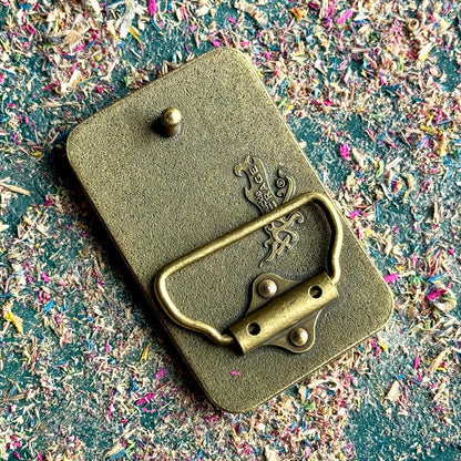 belt buckle, A multicolour layered jewellery piece made from recycled skateboard wood, handmade by Baltic Dew with.