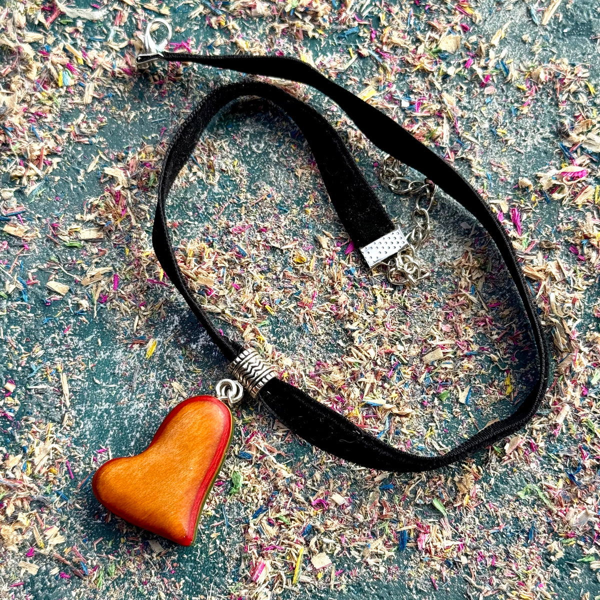 Skateboard Wood Choker featuring a polished wooden heart pendant on a black velvet strap with silver-tone accents.