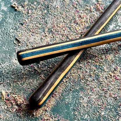 A multicolour layered hair stick made from recycled skateboard wood with oiled wooden finish, handmade by Baltic Dew