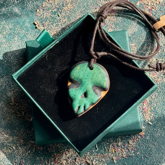 Green and brown pendant on a string in a green box