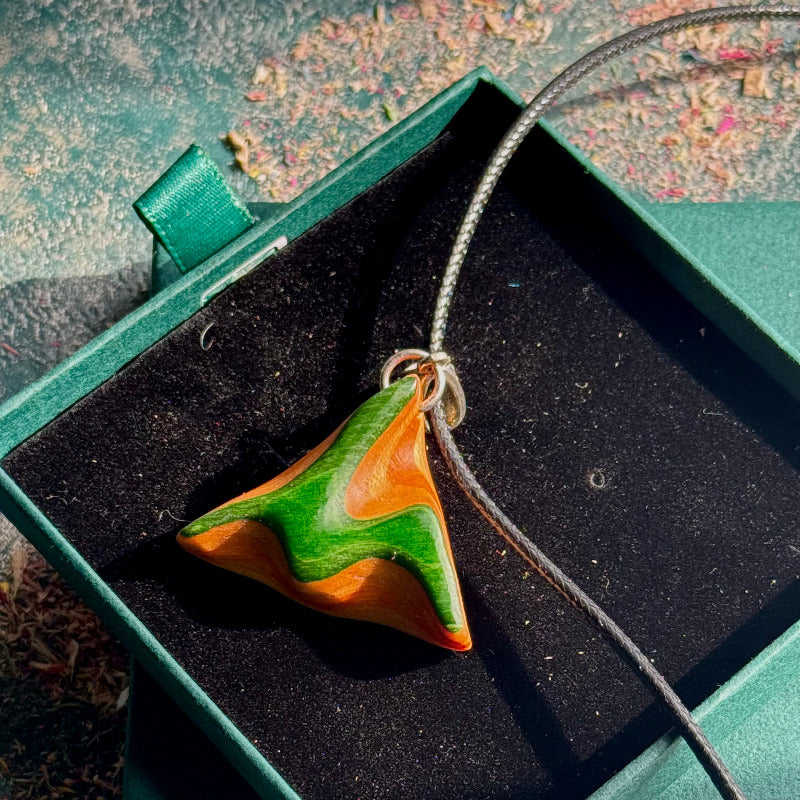 Orange Green Triangle Skateboard Pendant made of layered wood with smooth finish displayed in a green jewellery box