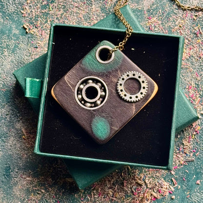 A multicolour layered pendant made from recycled skateboard wood with oiled wooden finish, handmade by Baltic Dew