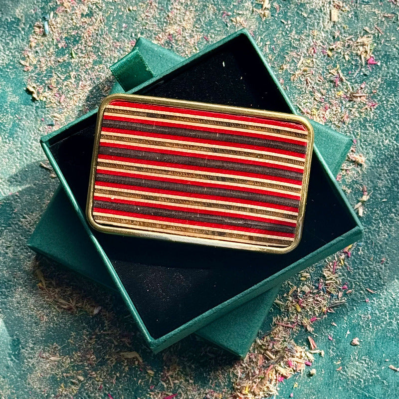 belt buckle, A grey, black and pink jewellery piece made from recycled skateboard wood, handmade by Baltic Dew with.