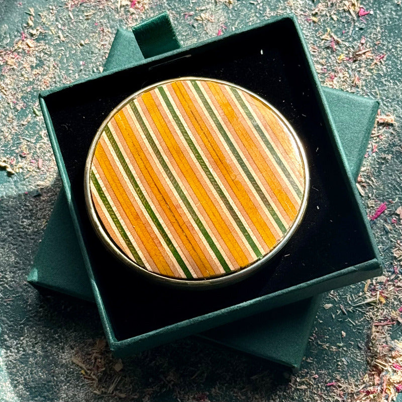 belt buckle, A multicolour layered jewellery piece made from recycled skateboard wood, handmade by Baltic Dew with.