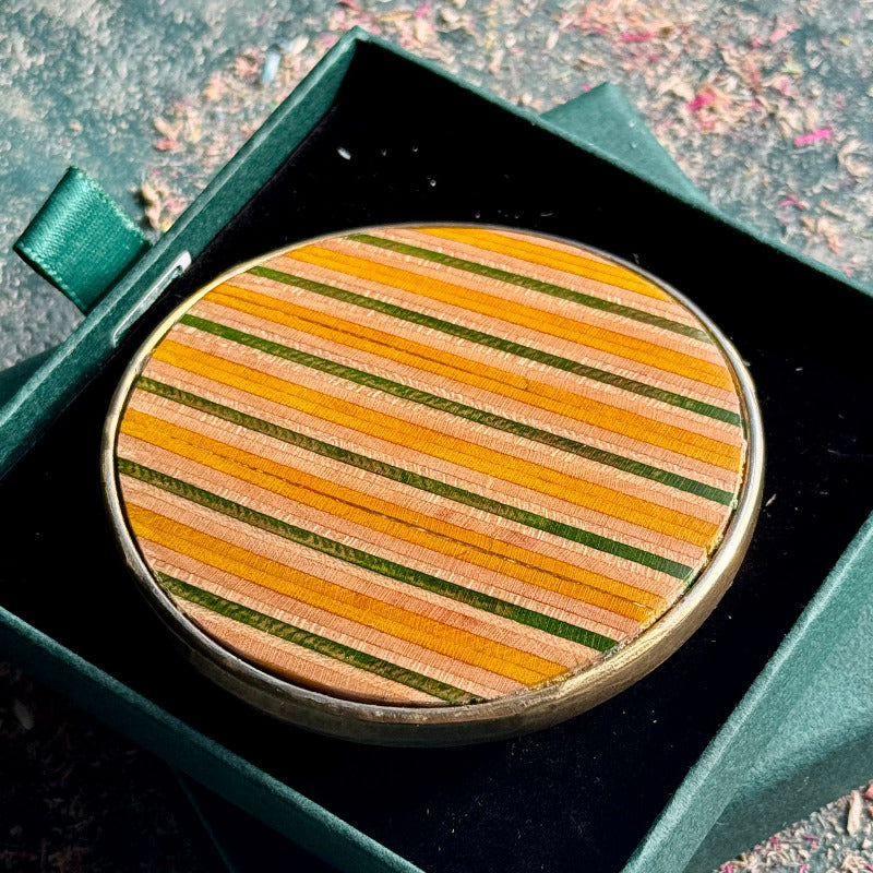 belt buckle, A multicolour layered jewellery piece made from recycled skateboard wood, handmade by Baltic Dew with.