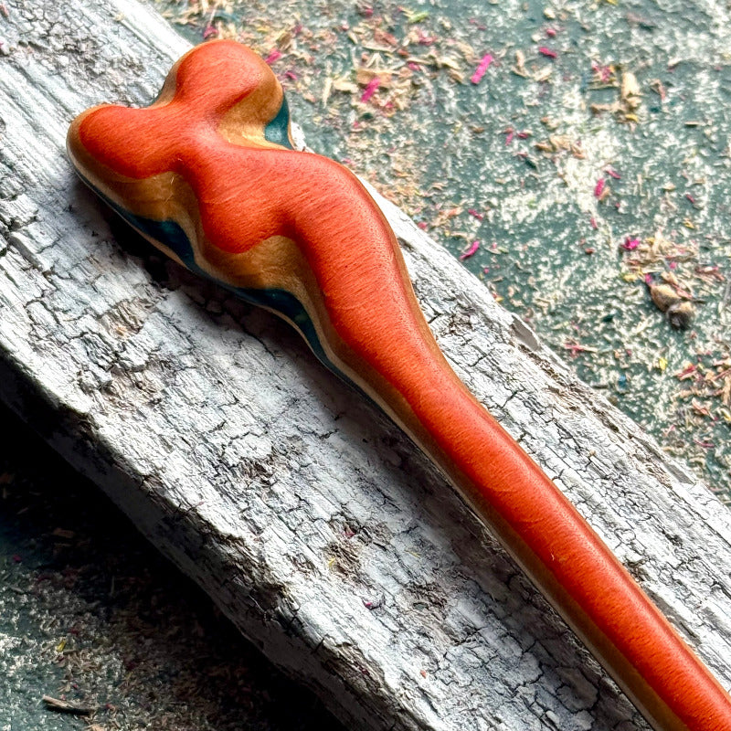 A multicolour layered hair stick made from recycled skateboard wood with oiled wooden finish, handmade by Baltic Dew