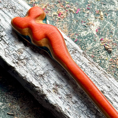 A multicolour layered hair stick made from recycled skateboard wood with oiled wooden finish, handmade by Baltic Dew