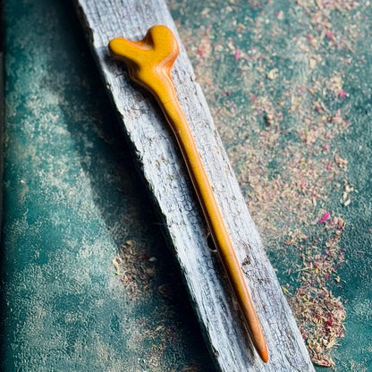 A grey and black hair stick made from recycled skateboard wood with oiled wooden finish, handmade by Baltic Dew