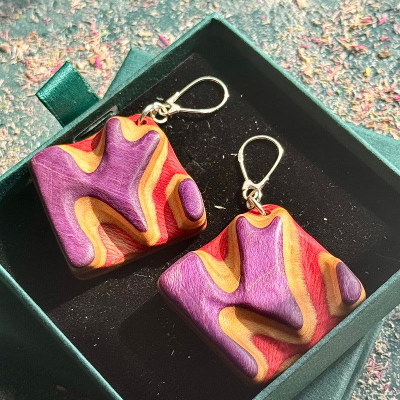 A multicolour layered ring made from recycled skateboard wood with glossy CA glue finish, handmade by Baltic Dew