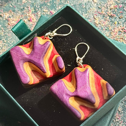 A multicolour layered ring made from recycled skateboard wood with glossy CA glue finish, handmade by Baltic Dew