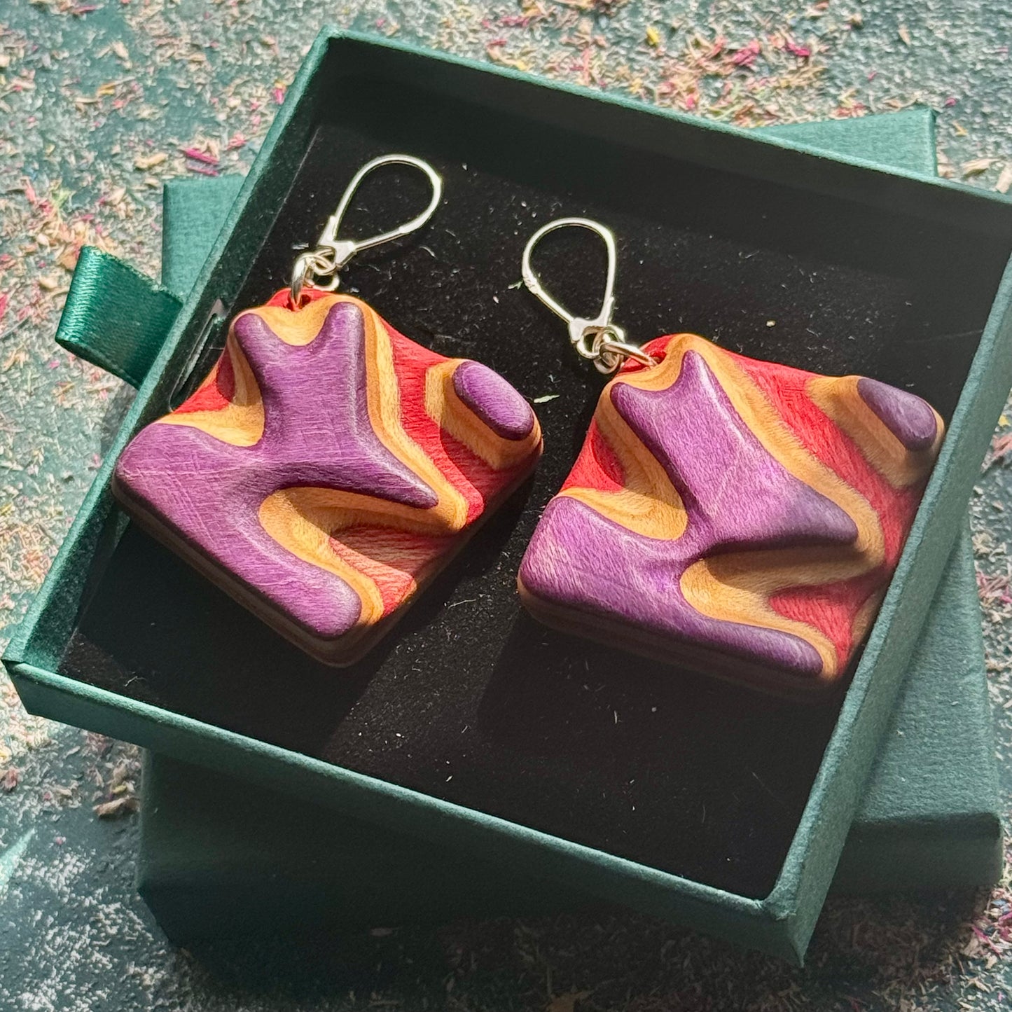 A multicolour layered ring made from recycled skateboard wood with glossy CA glue finish, handmade by Baltic Dew