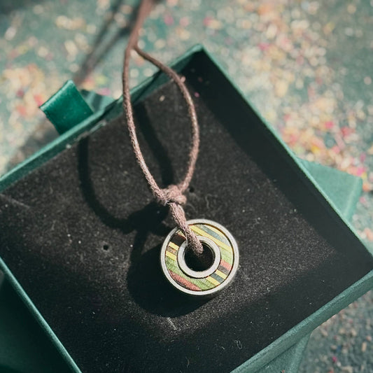 Necklace with a colorful pendant on a textured surface