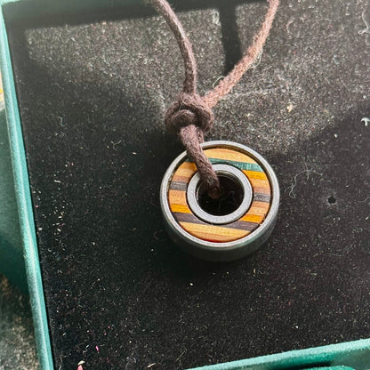 Necklace with a colorful pendant on a textured surface