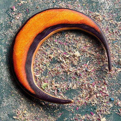 A multicolour layered jewellery piece made from recycled skateboard wood, handmade by Baltic Dew Crafted from recycled.