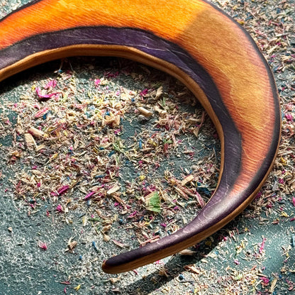 A multicolour layered jewellery piece made from recycled skateboard wood, handmade by Baltic Dew Crafted from recycled.