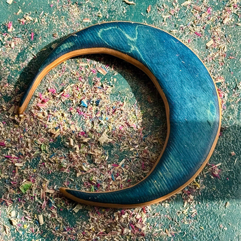 A multicolour layered jewellery piece made from recycled skateboard wood, handmade by Baltic Dew Crafted from recycled.