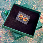 Wooden stud earrings in an open gift box, showing the scale of the round settings