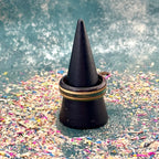Slim green, purple and teal skateboard maple ring on a black display cone.