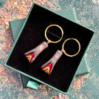 Recycled skateboard hoop earrings with red and black layered maple drops on gold stainless steel hoops.