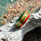 Orange, red and green skateboard maple ring with green, red and natural layers.