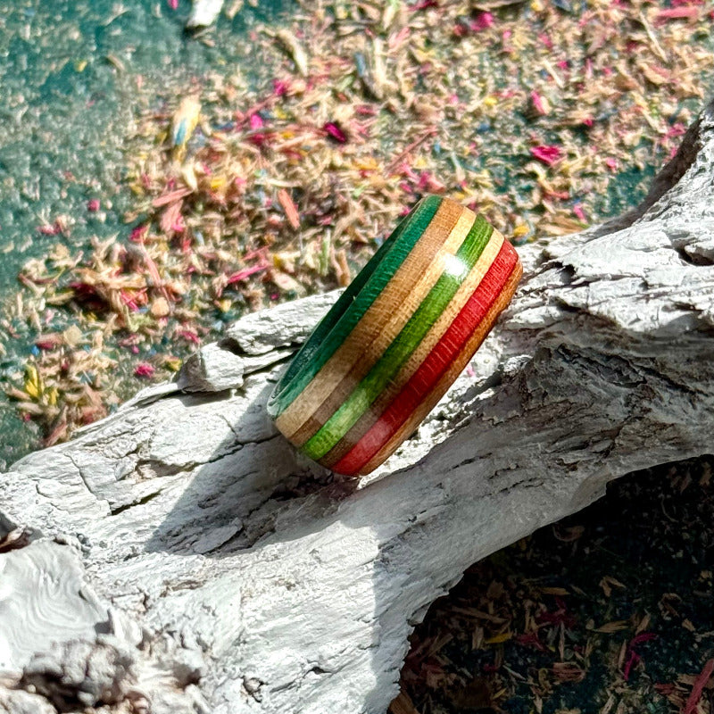 Orange, red and green skateboard maple ring with green, red and natural layers.