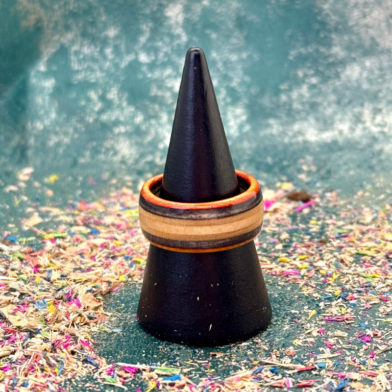 Orange and black skateboard maple ring on a black display cone.