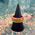 Orange, red and green skateboard maple ring on a black ring cone.