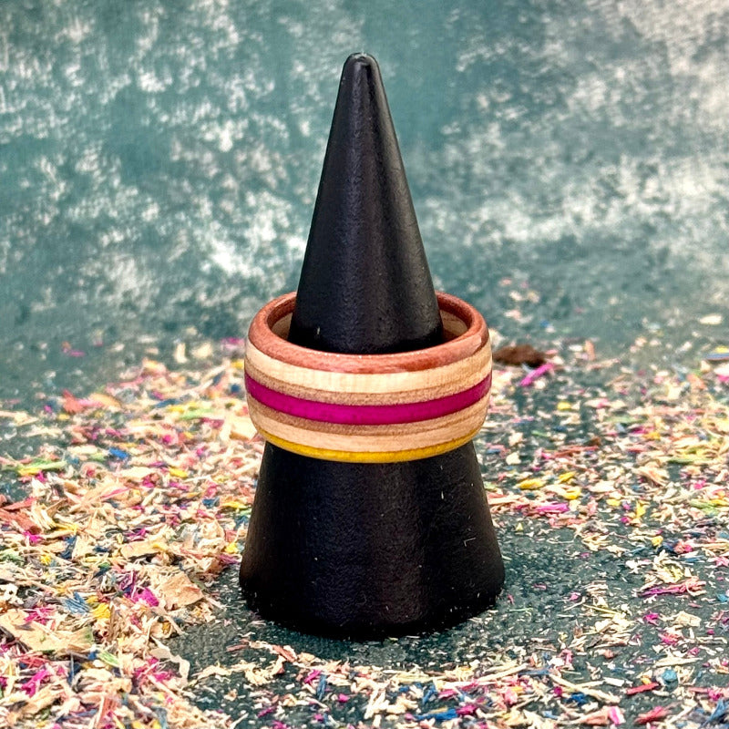 Yellow and pink skateboard maple ring seen from above on a black cone.