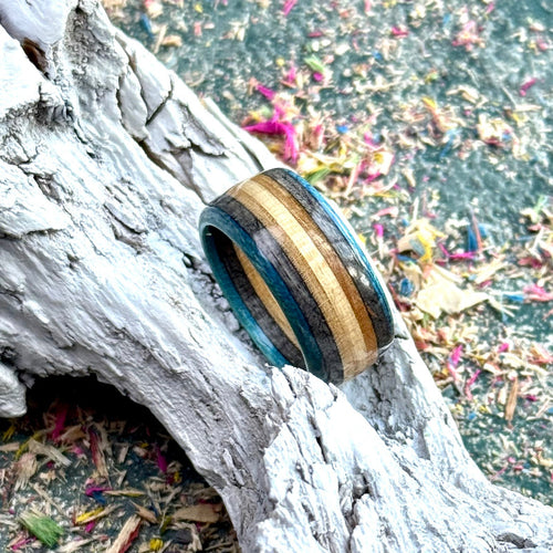Blue and black skateboard maple ring in blue and natural layers.