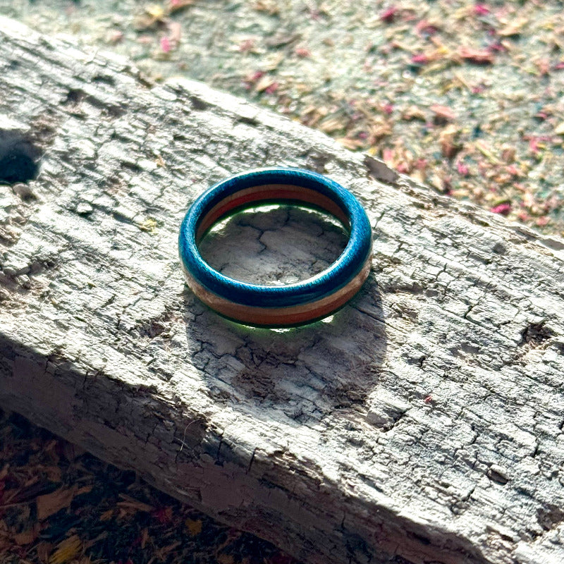 Slim skateboard maple ring showing the natural and coloured layers from the side.