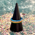 Slim green and blue skateboard maple ring on a black display cone.