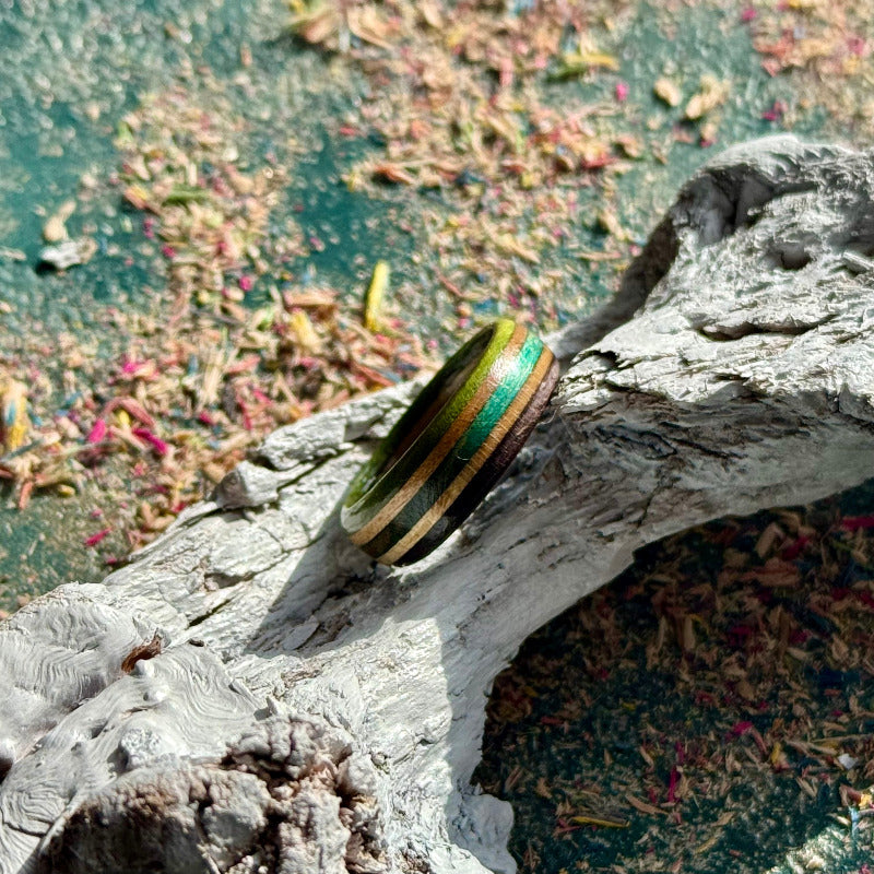 Slim skateboard maple ring with green, purple and teal stripes.